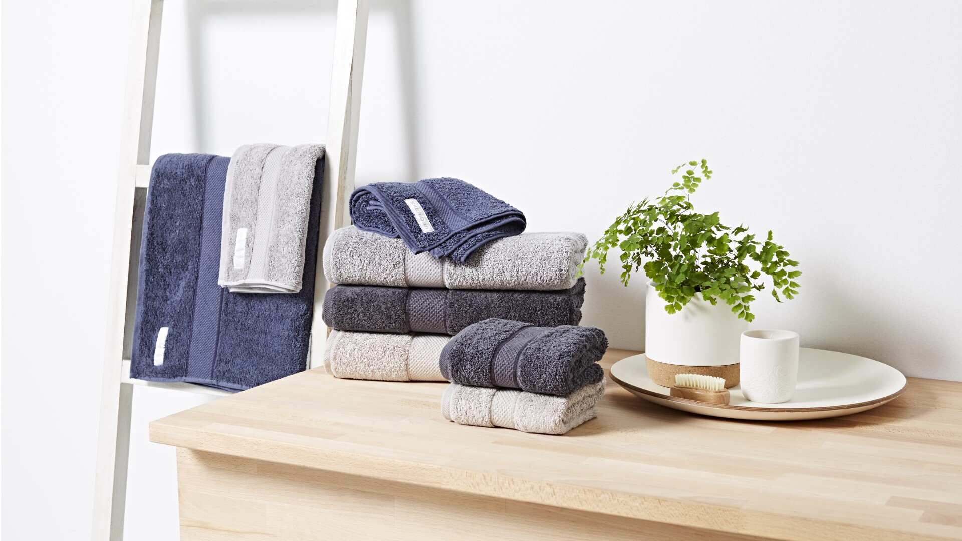 Assorted grey and dark steel blue towels